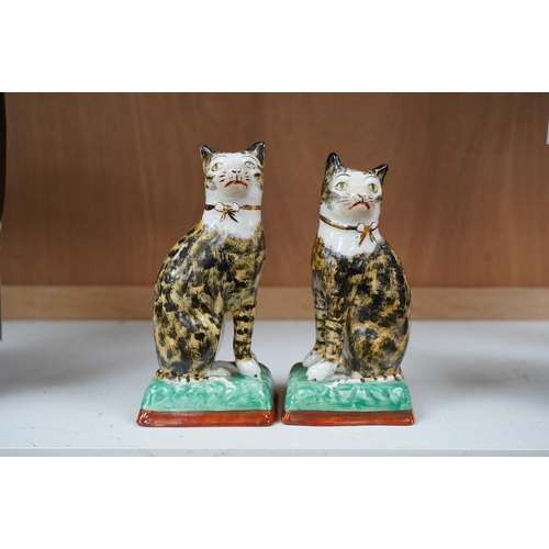 1421 - A pair of early 20th century Staffordshire cats, 17cm. Condition - good, some crazing