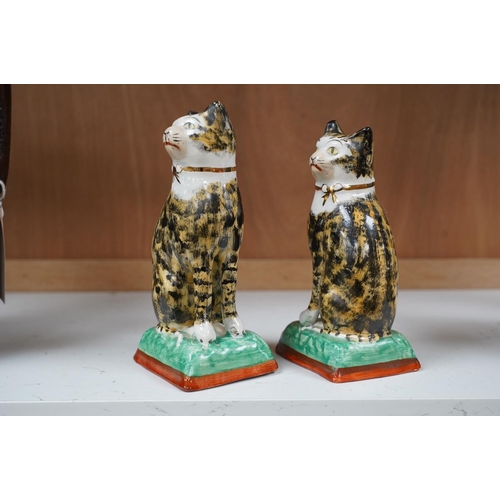 1421 - A pair of early 20th century Staffordshire cats, 17cm. Condition - good, some crazing