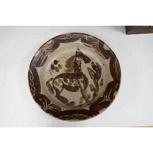 1432 - A Studio Pottery horse dish stamped PE? on the foot rim, 31cm diameter. Condition - good