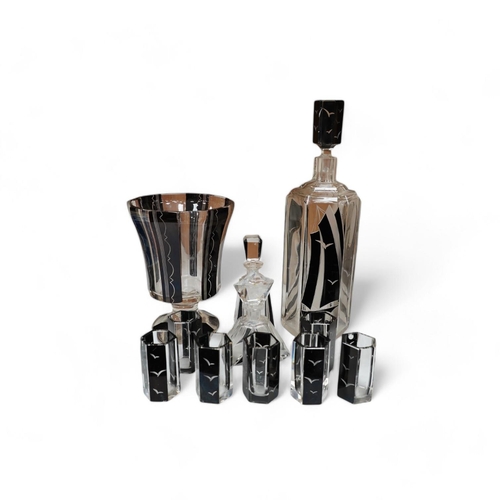 1434 - In the manner of Karl Palda (Czechoslovakian), an Art Deco flashed glass liqueur set comprising of a... 