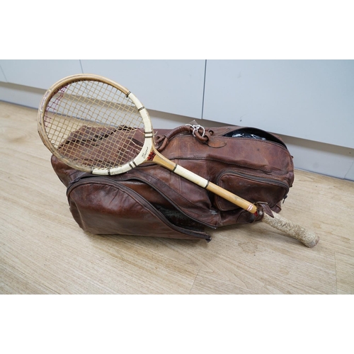 1445 - A leather sports holdall, with squash racket. Condition - poor to fair