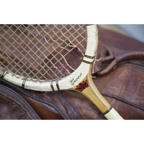 1445 - A leather sports holdall, with squash racket. Condition - poor to fair