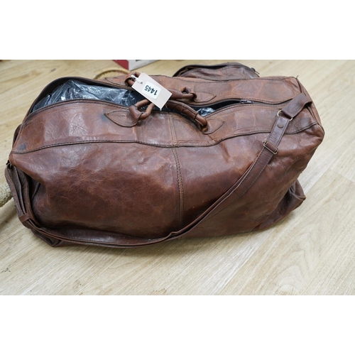 1445 - A leather sports holdall, with squash racket. Condition - poor to fair