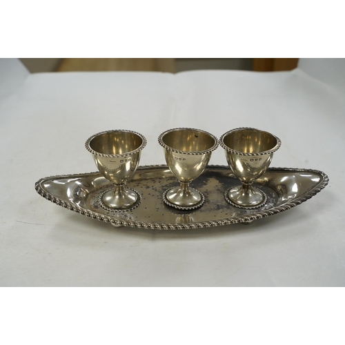 1837 - A late Victorian silver egg cruet, with three cups on a navette shaped stand, Chester, 1898, 25.8cm,... 