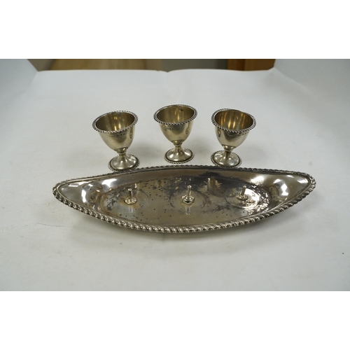 1837 - A late Victorian silver egg cruet, with three cups on a navette shaped stand, Chester, 1898, 25.8cm,... 