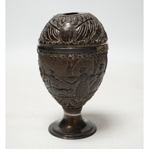 1848 - An early 19th century white metal mounted coconut cup, carved with continuous scene of figures, heig... 