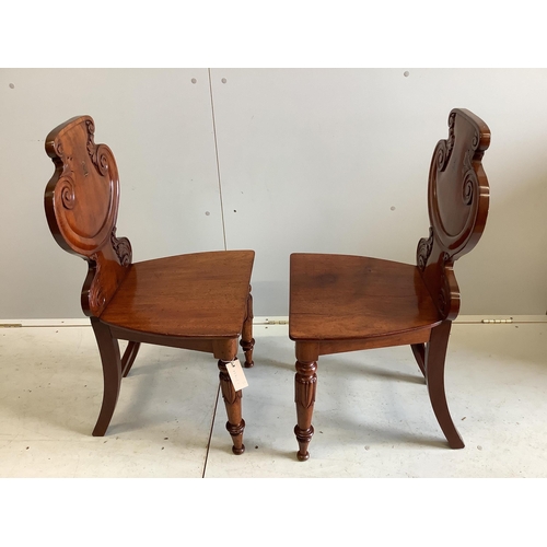 84 - A pair of William IV Irish mahogany hall chairs with painted armorials, width 44cm, depth 38cm, heig... 