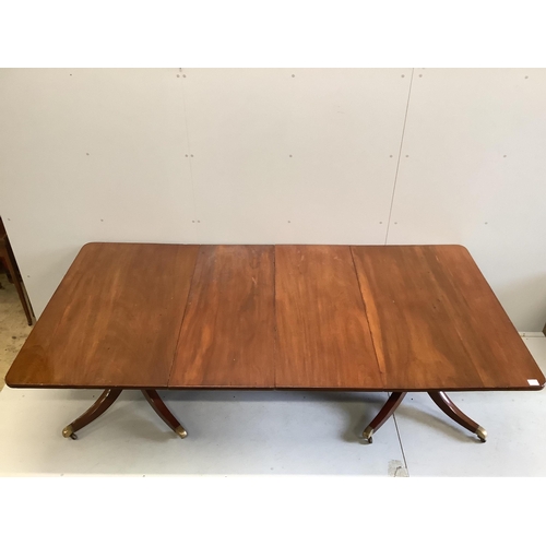 86 - A Regency mahogany twin pillar extending dining table, width approximately 240cm extended, two spare... 