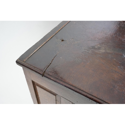 1 - A 17th century panelled oak coffer with plain single plank top and fielded panelled sides, on stile ... 