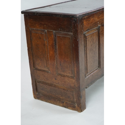 1 - A 17th century panelled oak coffer with plain single plank top and fielded panelled sides, on stile ... 