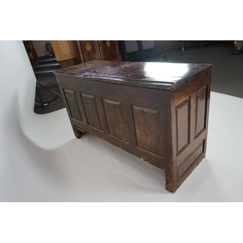 1 - A 17th century panelled oak coffer with plain single plank top and fielded panelled sides, on stile ... 