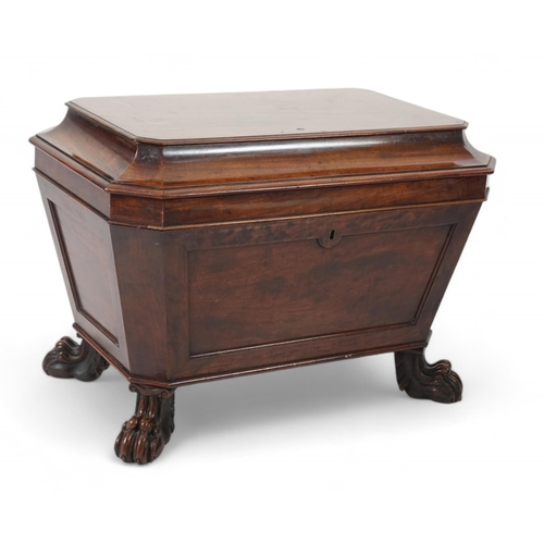 10 - A Regency mahogany sarcophagus wine cooler of traditional form with lead lined interior, on lion's p... 