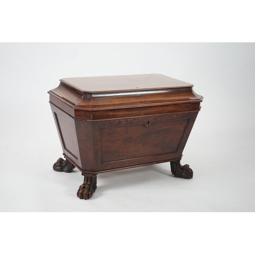 10 - A Regency mahogany sarcophagus wine cooler of traditional form with lead lined interior, on lion's p... 