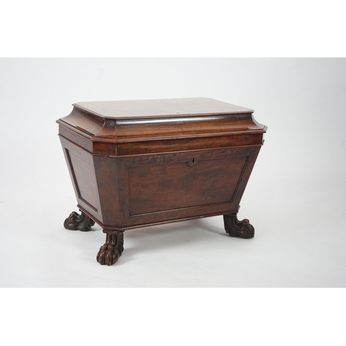 10 - A Regency mahogany sarcophagus wine cooler of traditional form with lead lined interior, on lion's p... 