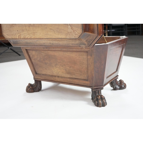 10 - A Regency mahogany sarcophagus wine cooler of traditional form with lead lined interior, on lion's p... 