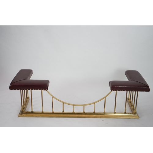 13 - A brass club fender with burgundy leather upholstered padded tops, 169cm wide, 61cm deep, 50cm high... 