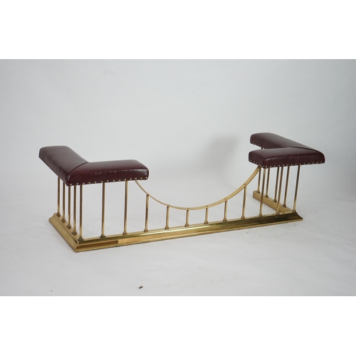 13 - A brass club fender with burgundy leather upholstered padded tops, 169cm wide, 61cm deep, 50cm high... 