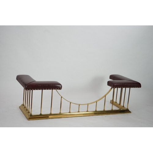 13 - A brass club fender with burgundy leather upholstered padded tops, 169cm wide, 61cm deep, 50cm high... 