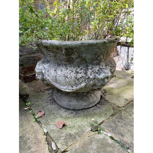 16 - A set of four reconstituted stone circular bulbous garden urns moulded with lion masks and swags, 50... 