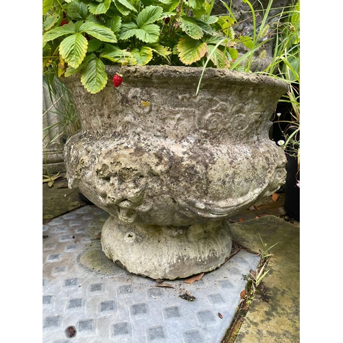 16 - A set of four reconstituted stone circular bulbous garden urns moulded with lion masks and swags, 50... 