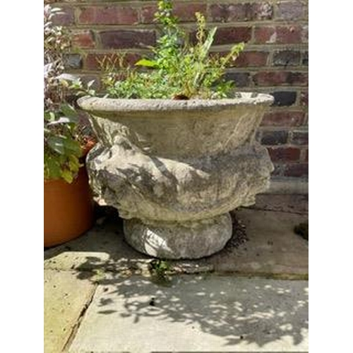 16 - A set of four reconstituted stone circular bulbous garden urns moulded with lion masks and swags, 50... 