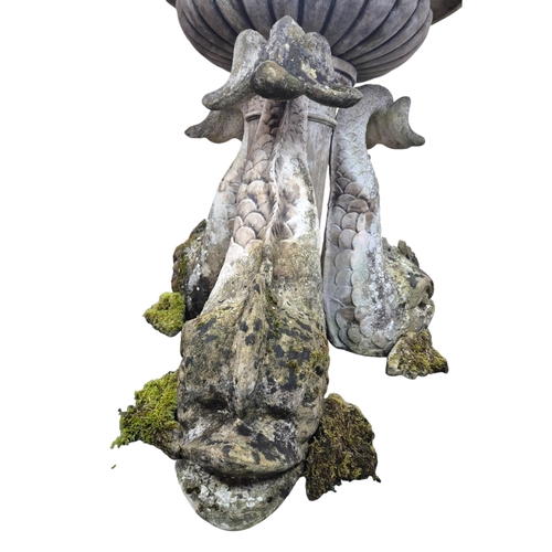 18 - A reconstituted stone bird bath with central bowl and dolphin brackets, on a circular plinth, 136cm ... 