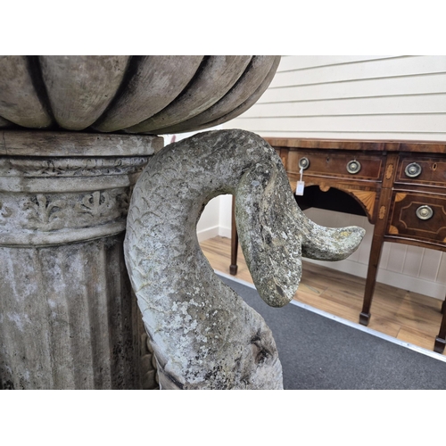 18 - A reconstituted stone bird bath with central bowl and dolphin brackets, on a circular plinth, 136cm ... 