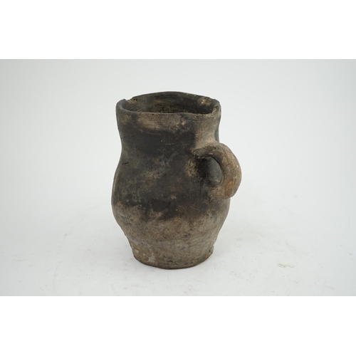 23 - An archaic pottery jug, Iron Age, excavated in Britain, 16cm wide over handle, 18.5cm high