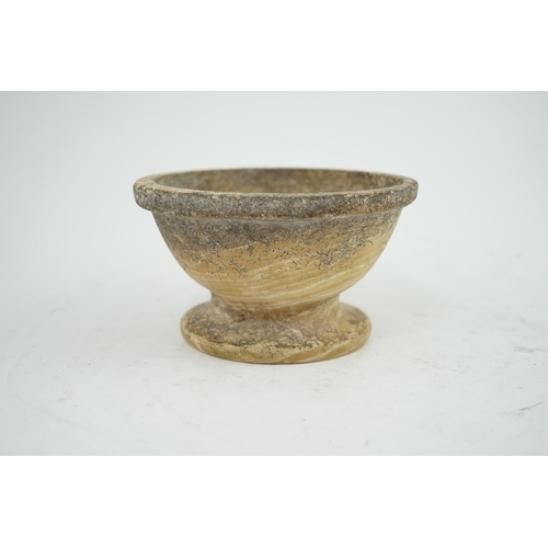 25 - An archaic alabaster footed bowl, possibly Egyptian, mineral encrustation, 15.25cm diameter, 8.5cm h... 