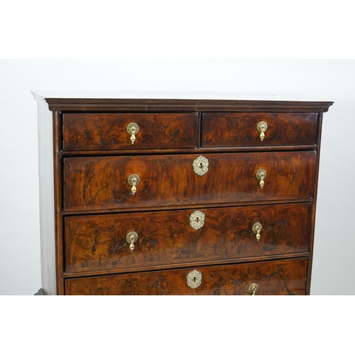 3 - An early 18th century and later crossbanded walnut chest on stand with moulded cornice, two short an... 