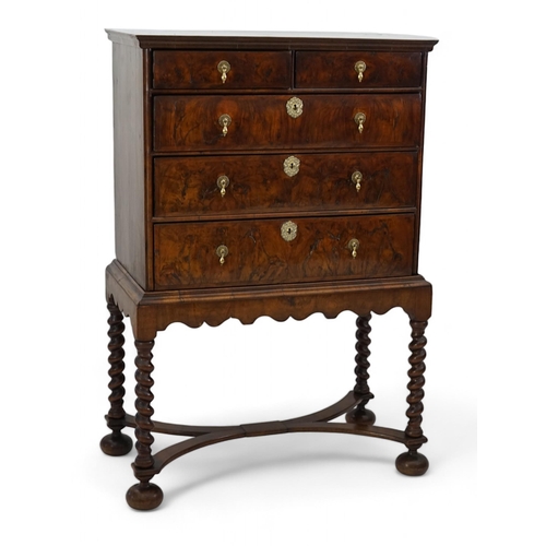 3 - An early 18th century and later crossbanded walnut chest on stand with moulded cornice, two short an... 