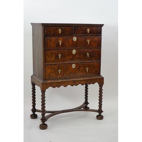 3 - An early 18th century and later crossbanded walnut chest on stand with moulded cornice, two short an... 