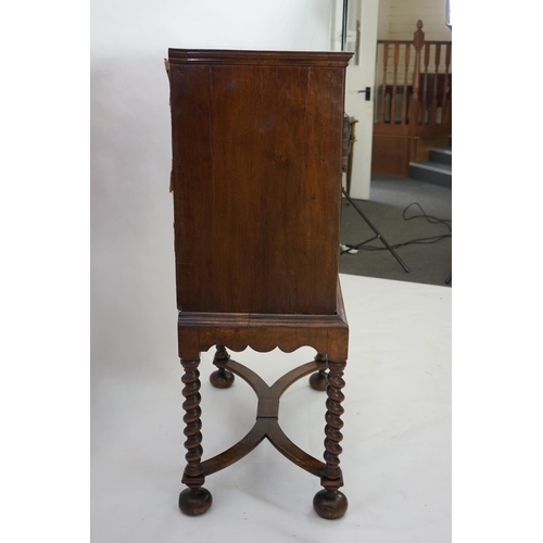 3 - An early 18th century and later crossbanded walnut chest on stand with moulded cornice, two short an... 