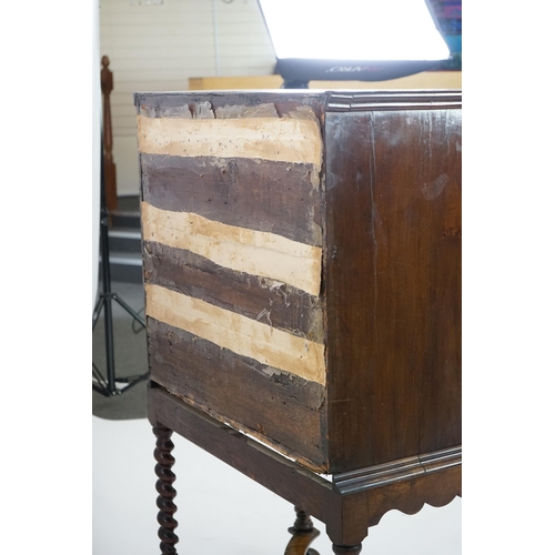 3 - An early 18th century and later crossbanded walnut chest on stand with moulded cornice, two short an... 