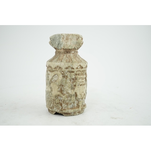 30 - A Gandharan Buddhist carved schist stem cup, carved in relief with figures and a stupa, 6.5cm diamet... 