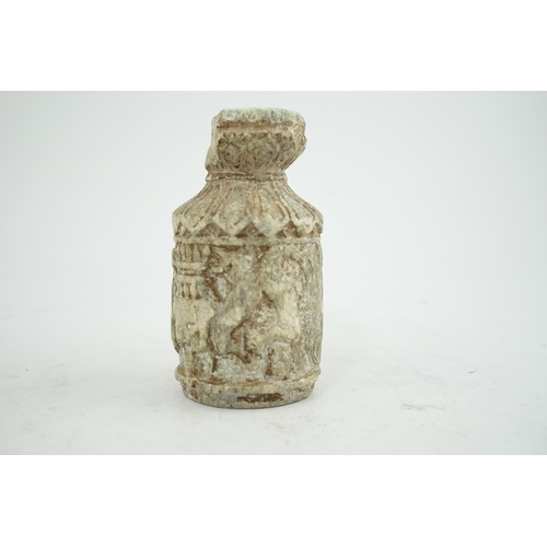 30 - A Gandharan Buddhist carved schist stem cup, carved in relief with figures and a stupa, 6.5cm diamet... 