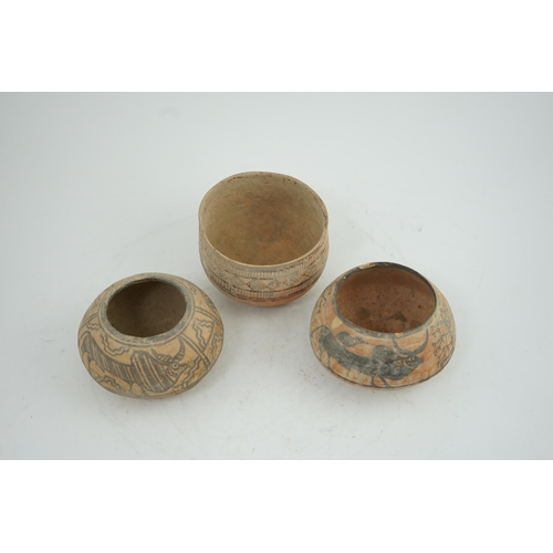 32 - Three Indus Valley pottery bowls, 3rd-2nd millennium BC, each painted in a black pigment, two with o... 