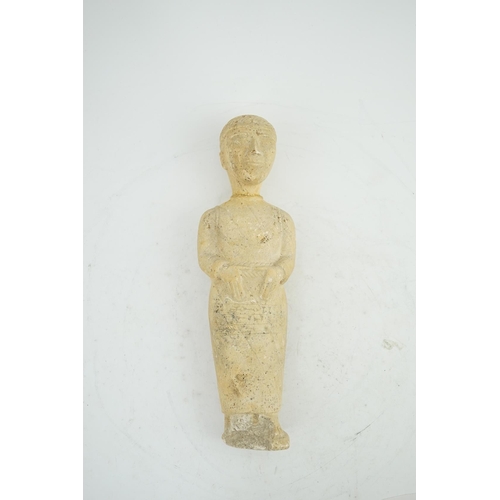 34 - An unusual limestone votive figure, with cuneiform inscription, possibly Mesopotamian, in standing p... 