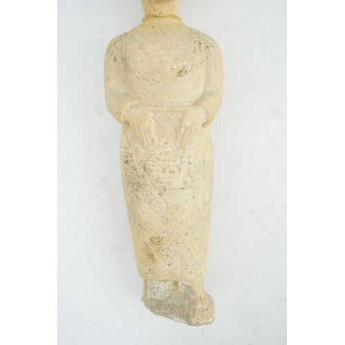 34 - An unusual limestone votive figure, with cuneiform inscription, possibly Mesopotamian, in standing p... 