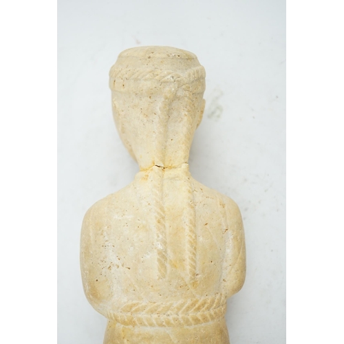 34 - An unusual limestone votive figure, with cuneiform inscription, possibly Mesopotamian, in standing p... 