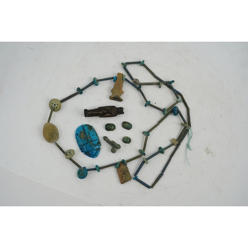 35 - An ancient Egyptian faience necklace, amulets and scarabs, late Kingdom to Ptolemaic period, the nec... 