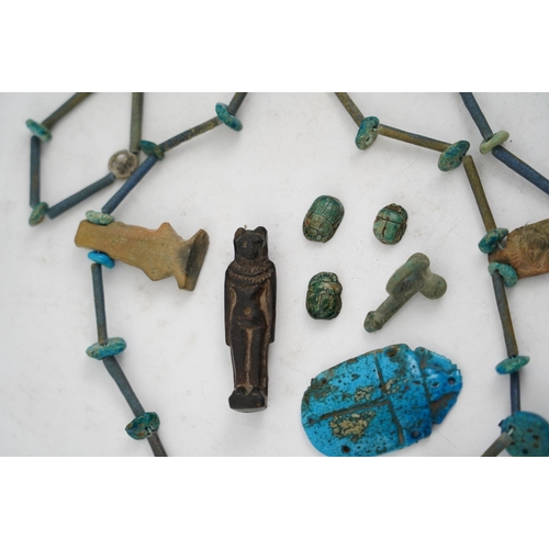 35 - An ancient Egyptian faience necklace, amulets and scarabs, late Kingdom to Ptolemaic period, the nec... 