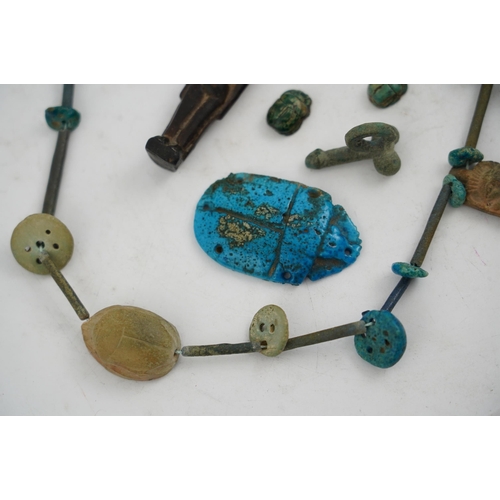 35 - An ancient Egyptian faience necklace, amulets and scarabs, late Kingdom to Ptolemaic period, the nec... 