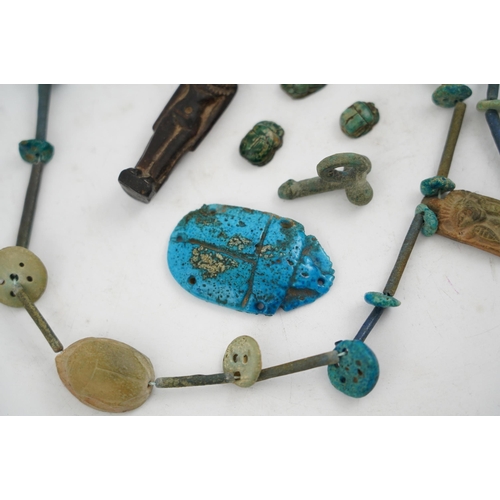 35 - An ancient Egyptian faience necklace, amulets and scarabs, late Kingdom to Ptolemaic period, the nec... 