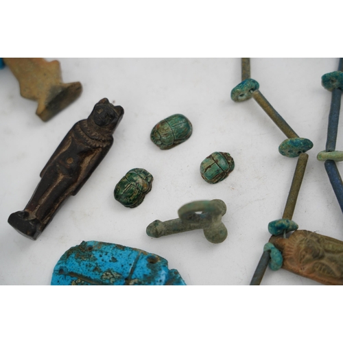 35 - An ancient Egyptian faience necklace, amulets and scarabs, late Kingdom to Ptolemaic period, the nec... 