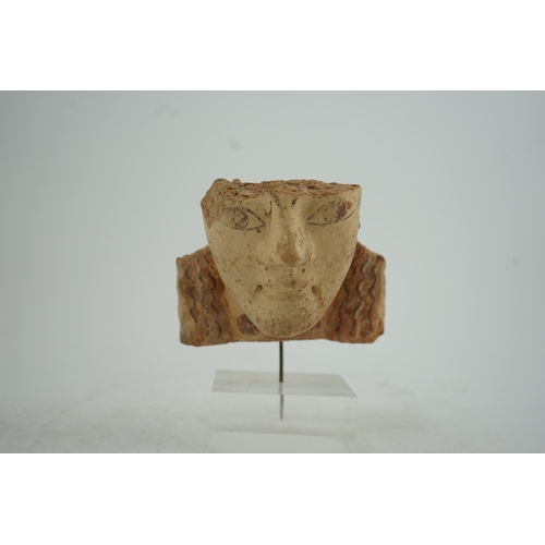 39 - An Etruscan terracotta antefix, modelled as a head with polychrome painted features, 6th-5th century... 