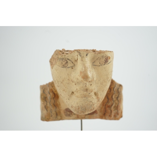 39 - An Etruscan terracotta antefix, modelled as a head with polychrome painted features, 6th-5th century... 