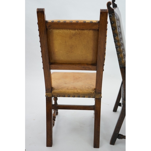 4 - A set of fourteen 17th century style oak dining chairs including a pair of carvers, with brass studd... 