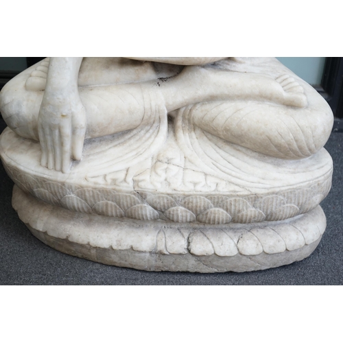 41 - A massive Burmese marble seated figure of Buddha Shakyamuni, 18th/19th century, seated on a double l... 