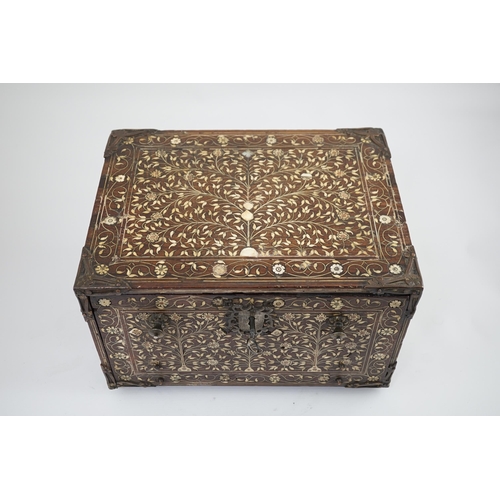 42 - An early 17th century Indo-Portuguese ivory inset hardwood travelling chest with brass loop handles,... 